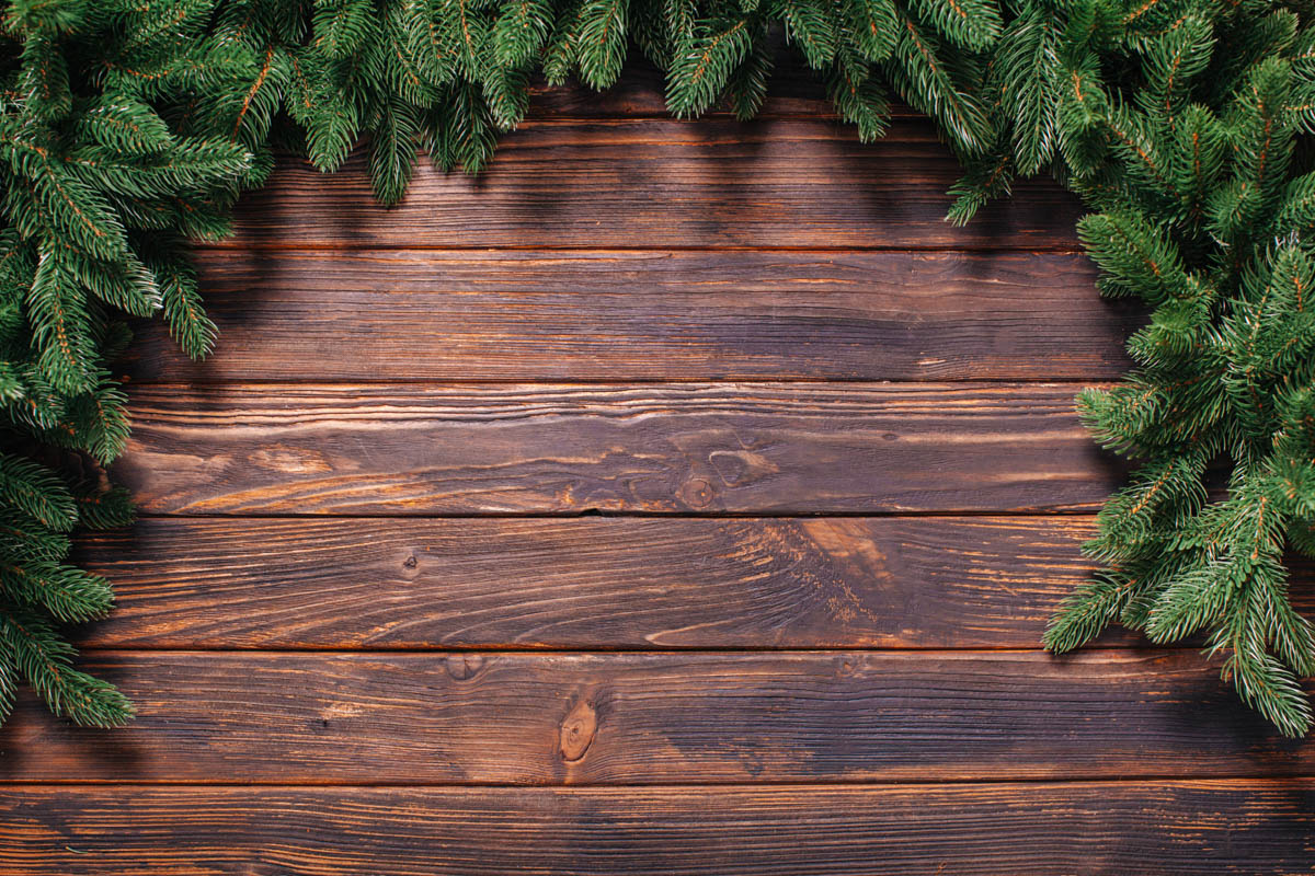 Wood surface with evergreen décor, warm seasonal styling